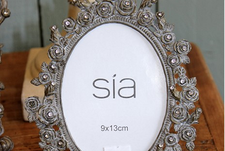 Photograph frame, oval, grey with flower effect.